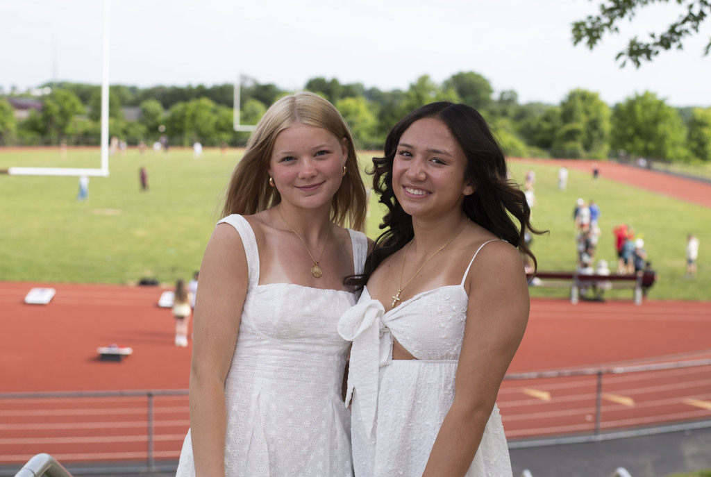 2 girls posing outside by the track