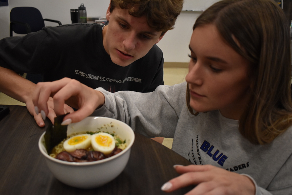 Dylan and Harper perfectly place their final piece in their Ramen dish for food science.