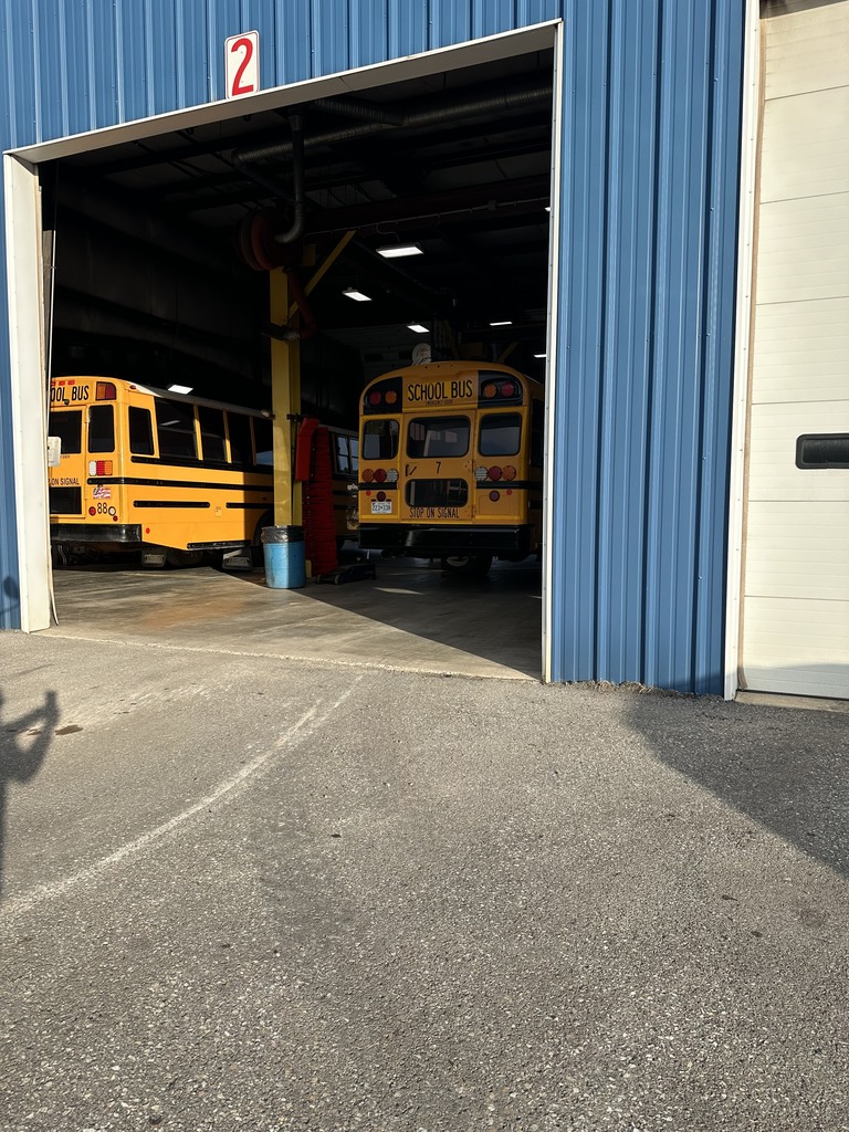 Image of a school bus in a garage for its inspection.