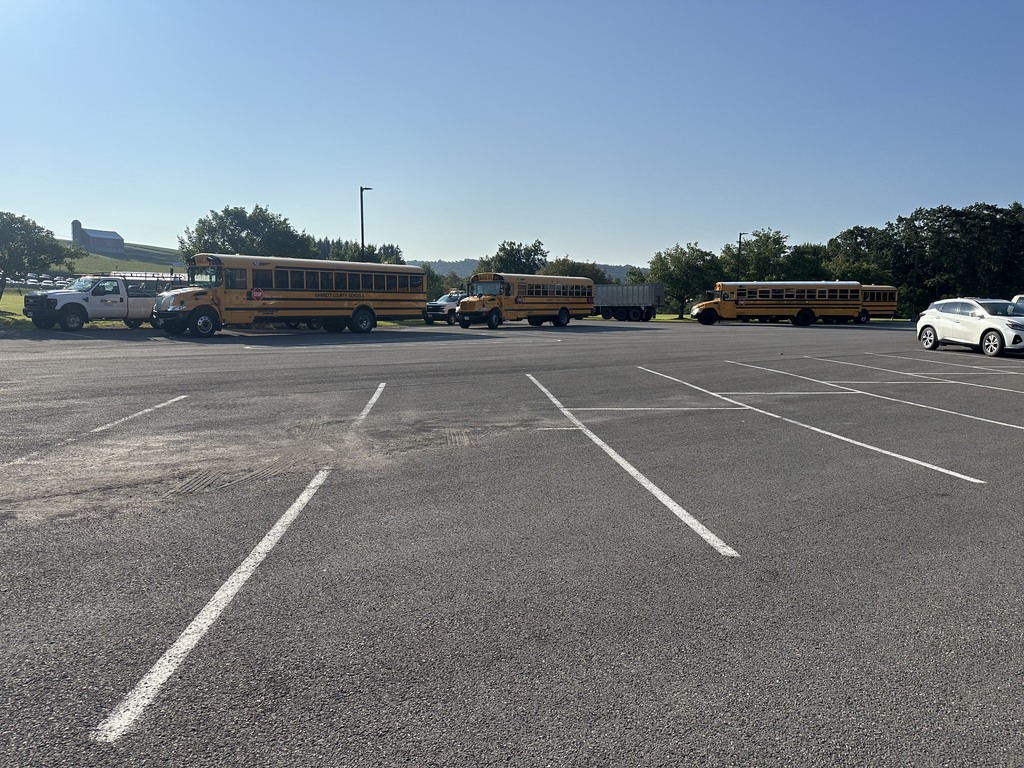 Image of school buses in a parking lot for inspection.