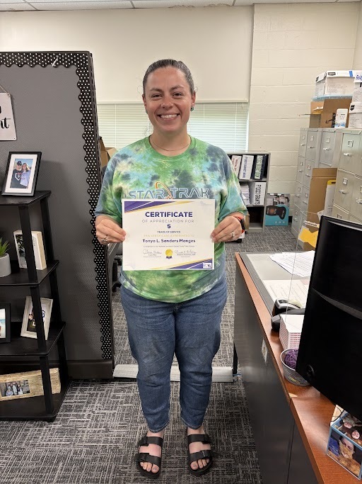 Image of Mrs. Tonya Sanders-Manges holding her years of service certificate.