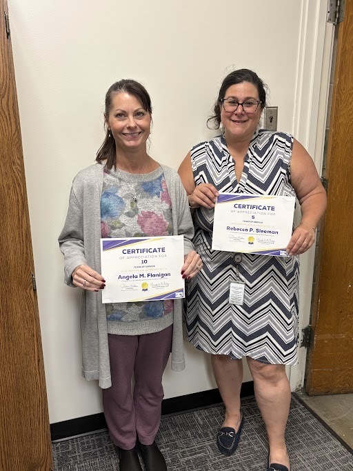 Image of Ms. Angela Flanigan and Mrs. Rebecca Sleeman holding their years of service certificates.
