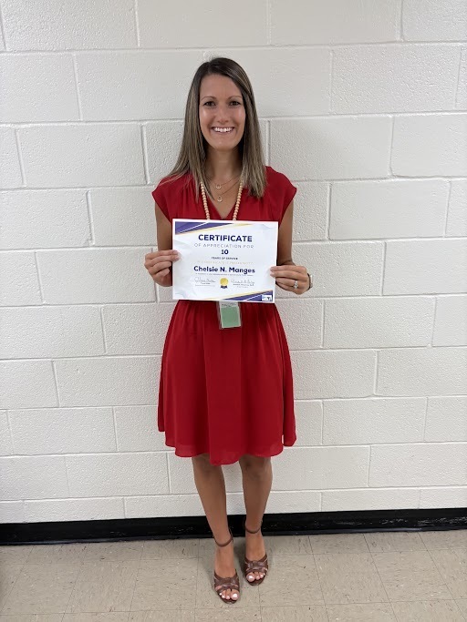 Image of Dr. Chelsie Manges holding her years of service certificate.