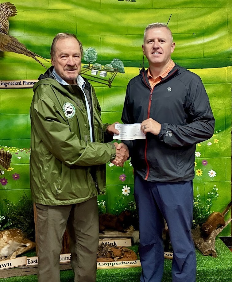 Image of Wendell Beitzel, NGHS Class of 1960 representative, presenting a check to Jason Shank, Hickory Environmental Education Center.