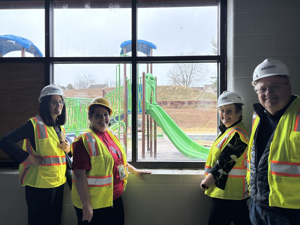GCPS Administrators and Board Members review the progress of renovations to the future Broad Ford School, pictured here in front of a window overlooking the playground..
