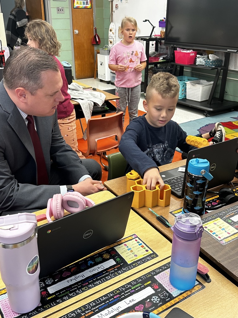 Dr. Michael interacts with a student at Crellin Elementary.
