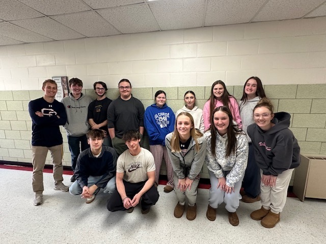 Students pose together in a hallway, after being recognized as Hickory's Finest for December 2025.