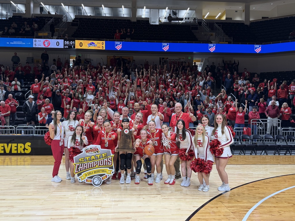 Image of the Lady Rams holding a state champions sign on a basketball court.