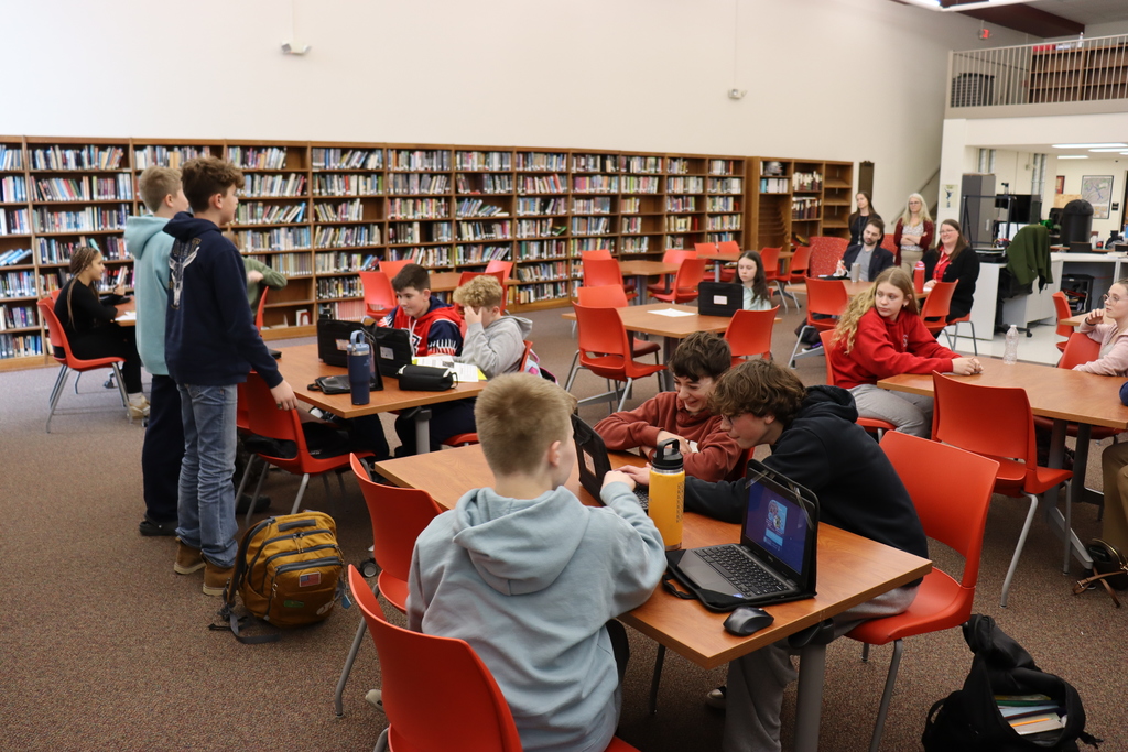 Students discuss their product with classmates and the "sharks."