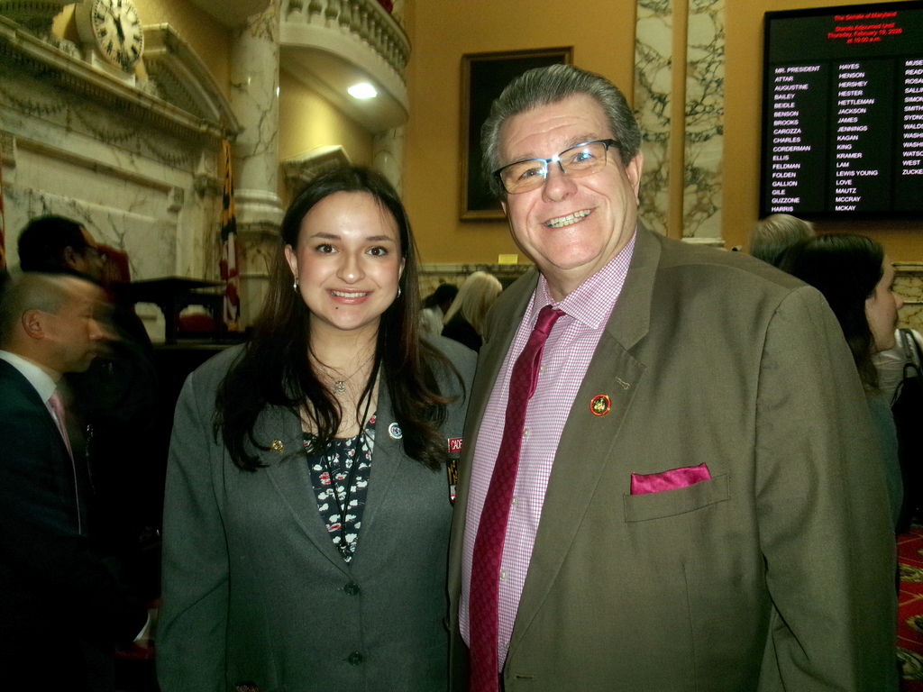 Image of Ms. Natividad, posing with a state delegate.