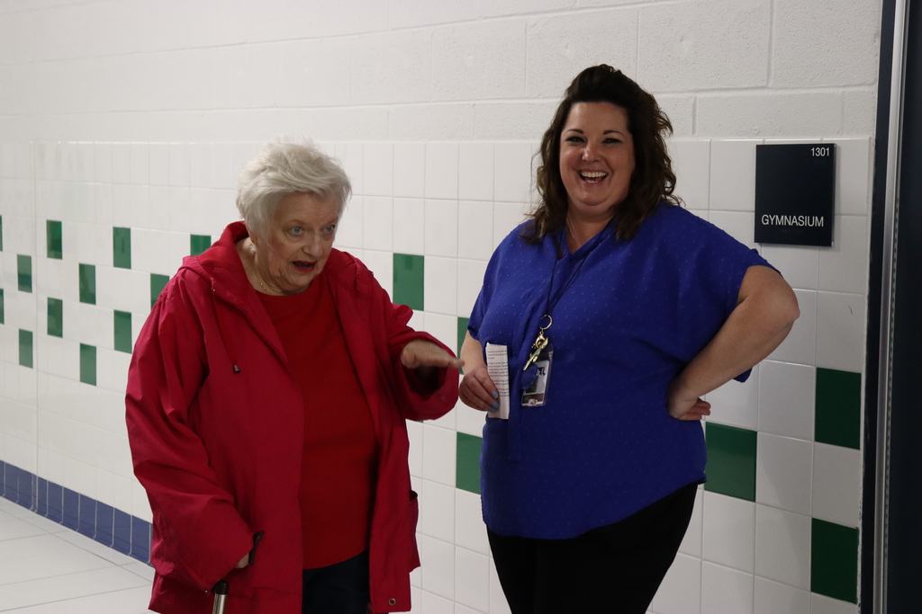 Mrs. Wise listens to a story from an attendee at the ribbon cutting ceremony.