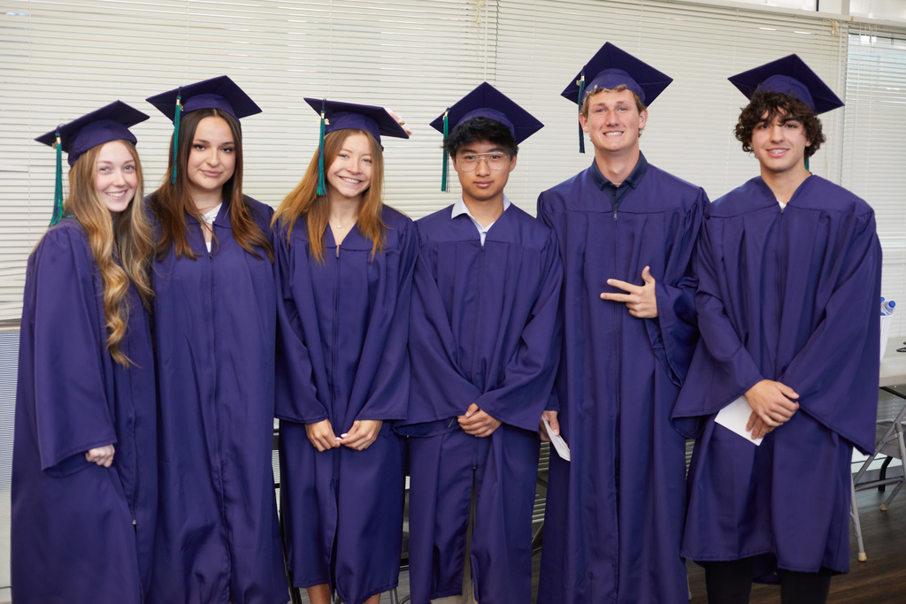 Image of six GCPS seniors, posed together in cap and gown, who attained an associate degree from Garrett College, in addition to their high school diploma.