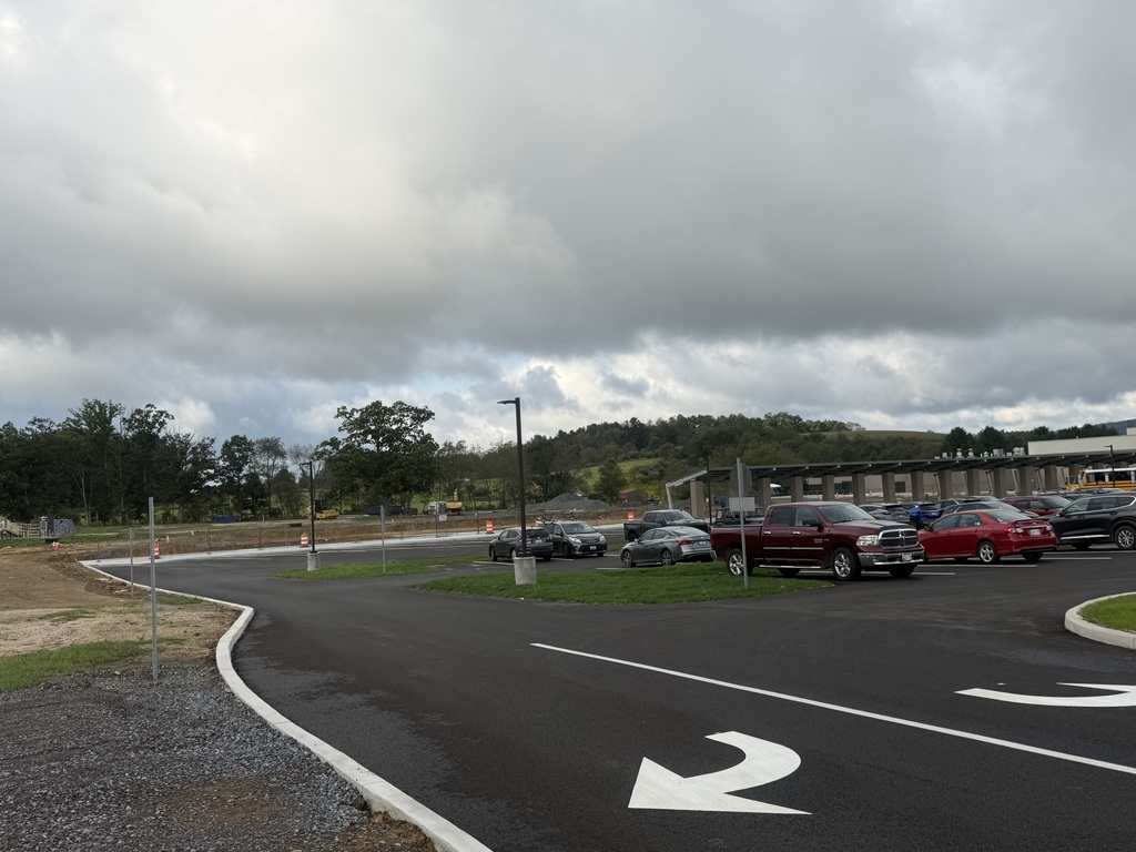 Image of the parking lot exit at Broad Ford School, with newly excavated land in the background.