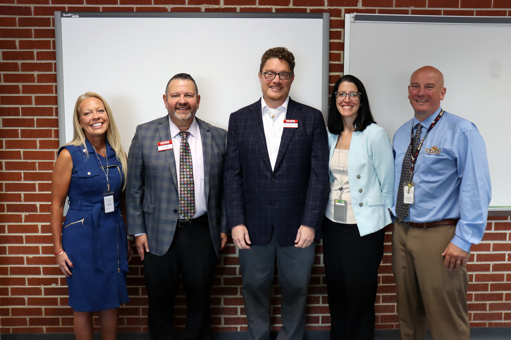Image of GCPS and FSU administrators posed together in front of a wall.