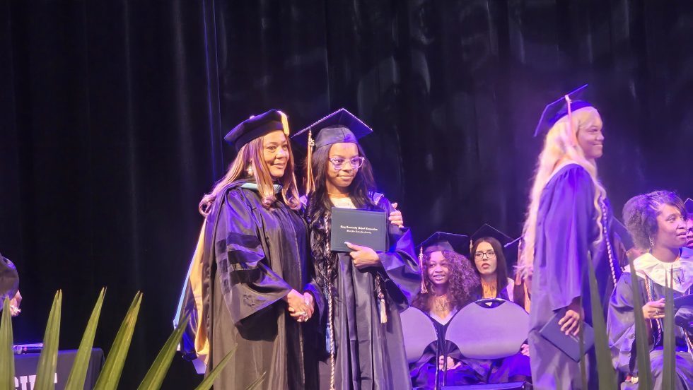 High School students showing their graduation diplomas