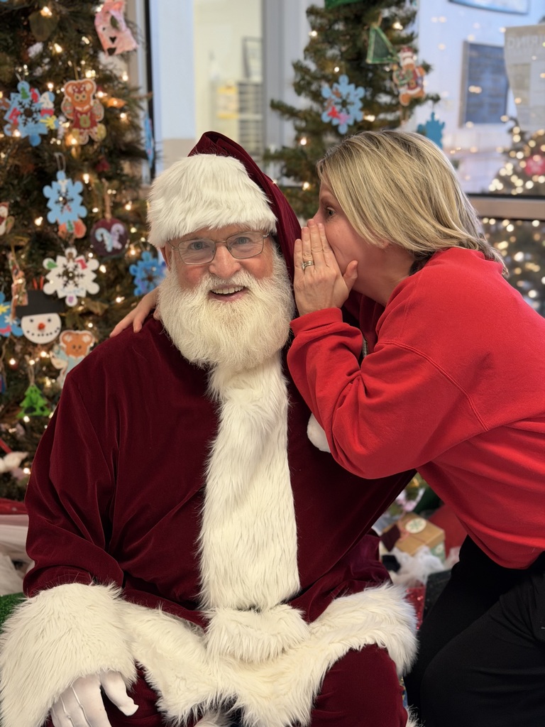 Mrs. Brune whispering to Santa