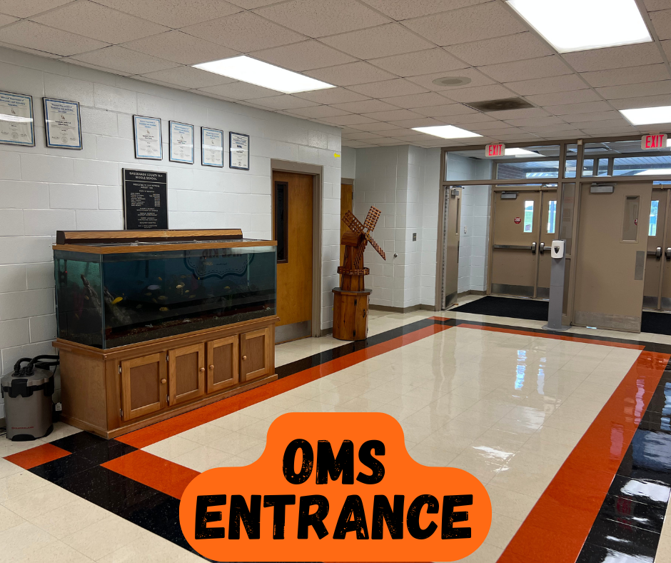 Wide hallway with aquarium and decorative objects. White walls and floors with orange, black, and white trim.