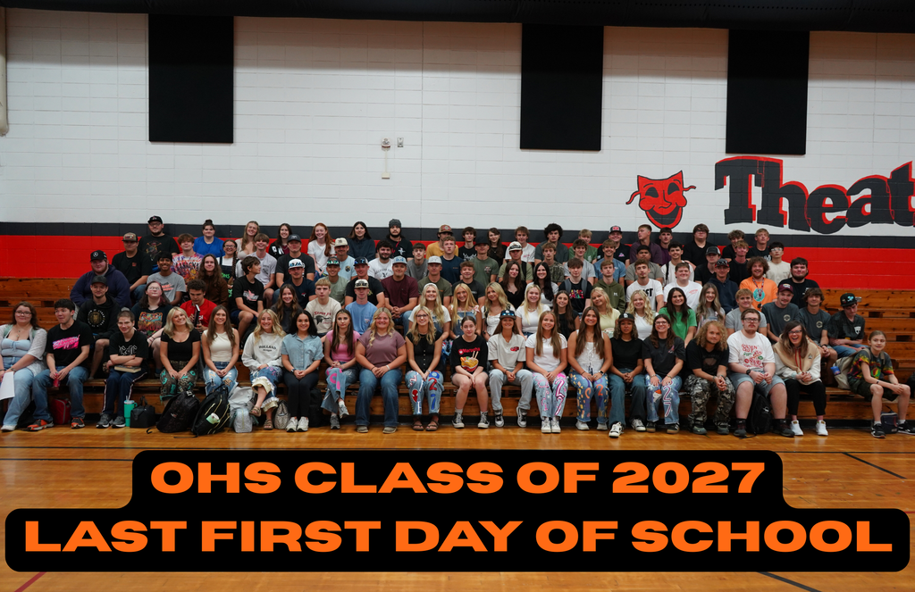 A large group of students sits on bleachers in a gym. The banner reads "OHS CLASS OF 2027 LAST FIRST DAY OF SCHOOL."