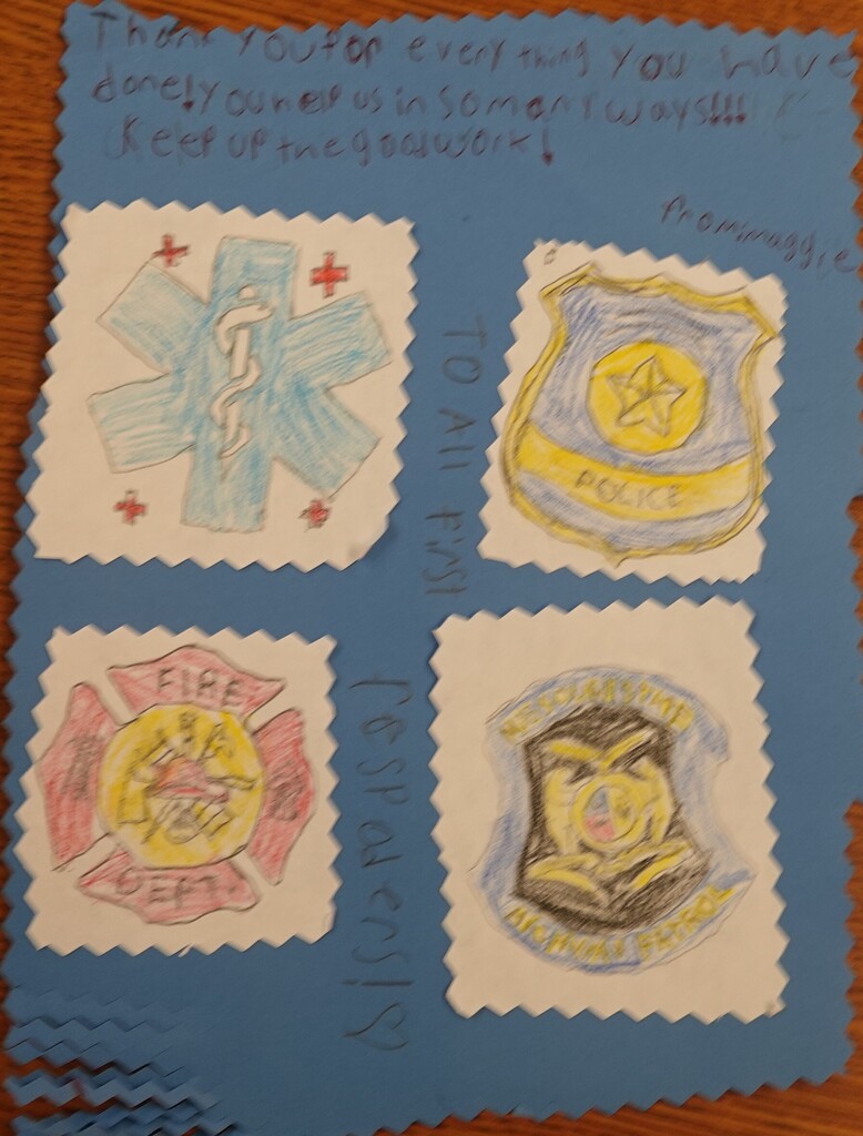 Hand-drawn blue badge with symbols for EMS, police, fire, and sheriff. Handwritten message on blue background.