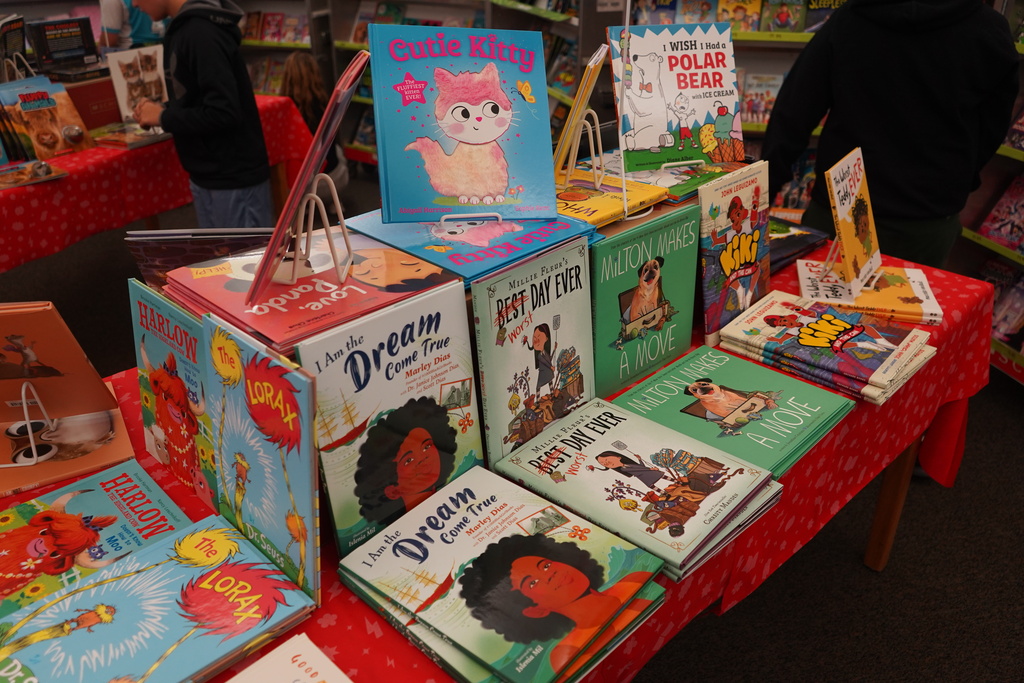 A table with books on it, including Dream Big, Little Dreamers, and more. A table in front.