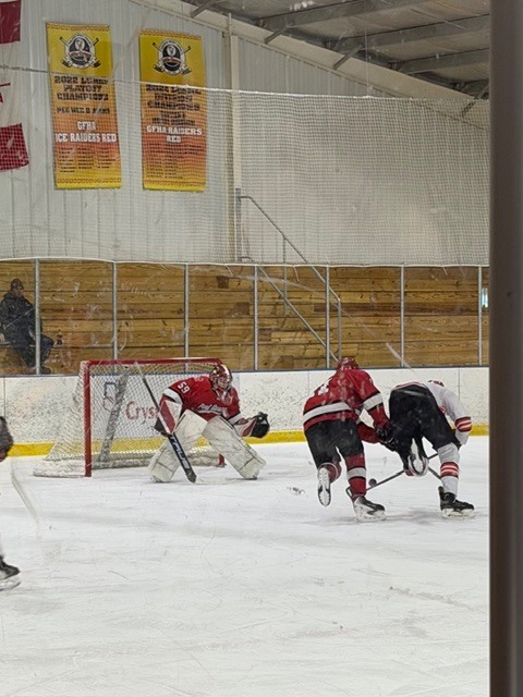 Goalie in net ready to make a save.