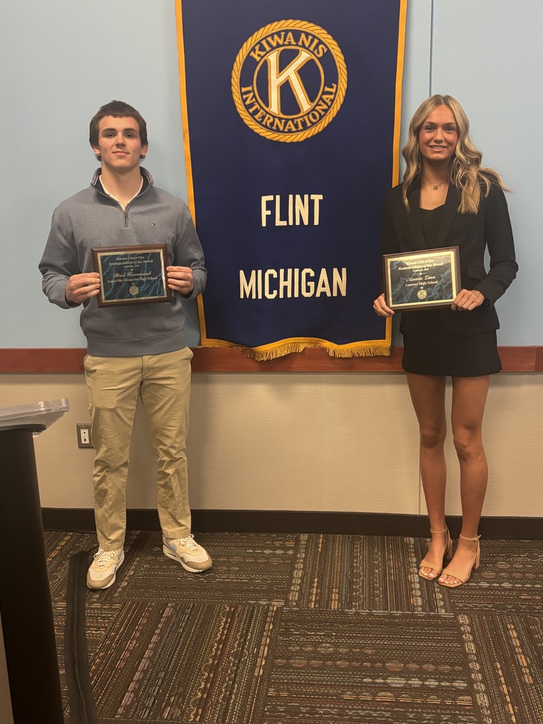 Averie Zinn and Fred from Lakeville pictured in front of Kiwanis Club Flag