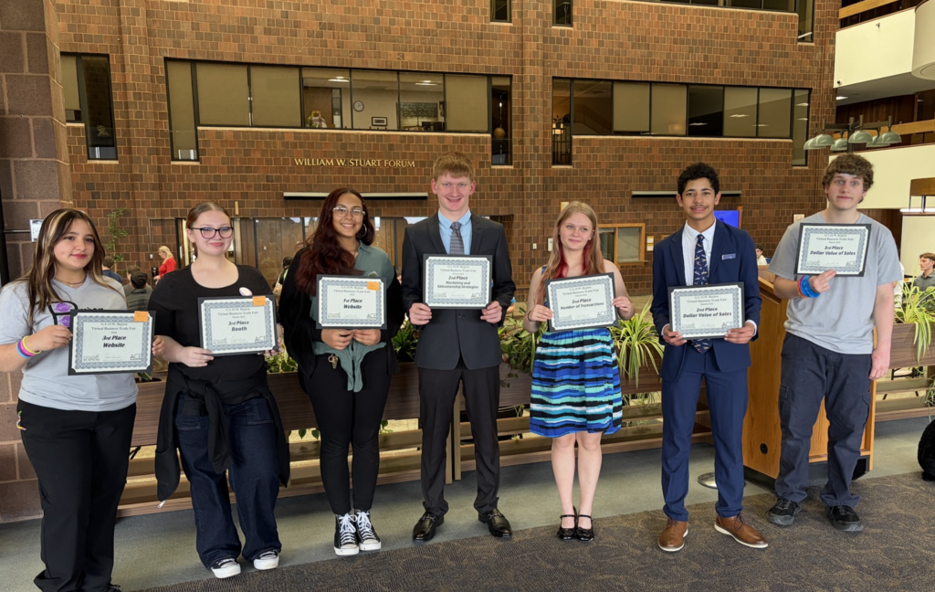 Students won won an award holding them in a group photo at Genesee Community College.