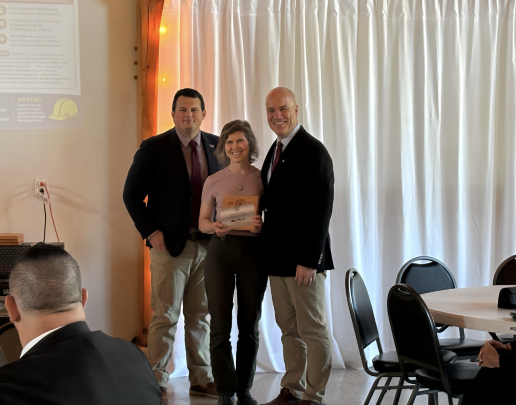 Nick D’Amuro, executive director of the Wyoming County Business Education Council, stands with Darryl McLaughlin, Perry CSD superintendent, and a representative from Act 4 Books during the Wyoming County BEC Annual Breakfast, where Act 4 Books was recognized as Perry CSD’s Business Partner of the Year.