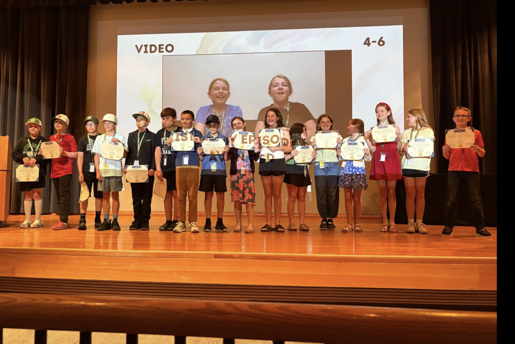 Students in the Grades 4–6 Video category were recognized on stage after earning a DIGIES award for their project. They proudly displayed their certificates as they celebrated their achievement alongside their teammates.