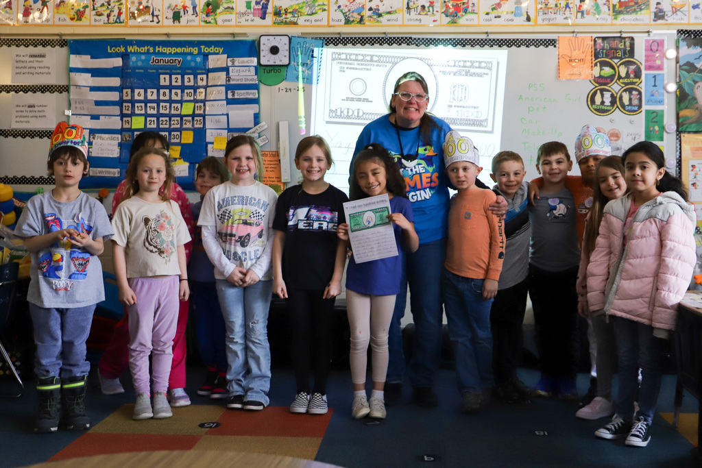students smiling at camera wearing 100 days hats