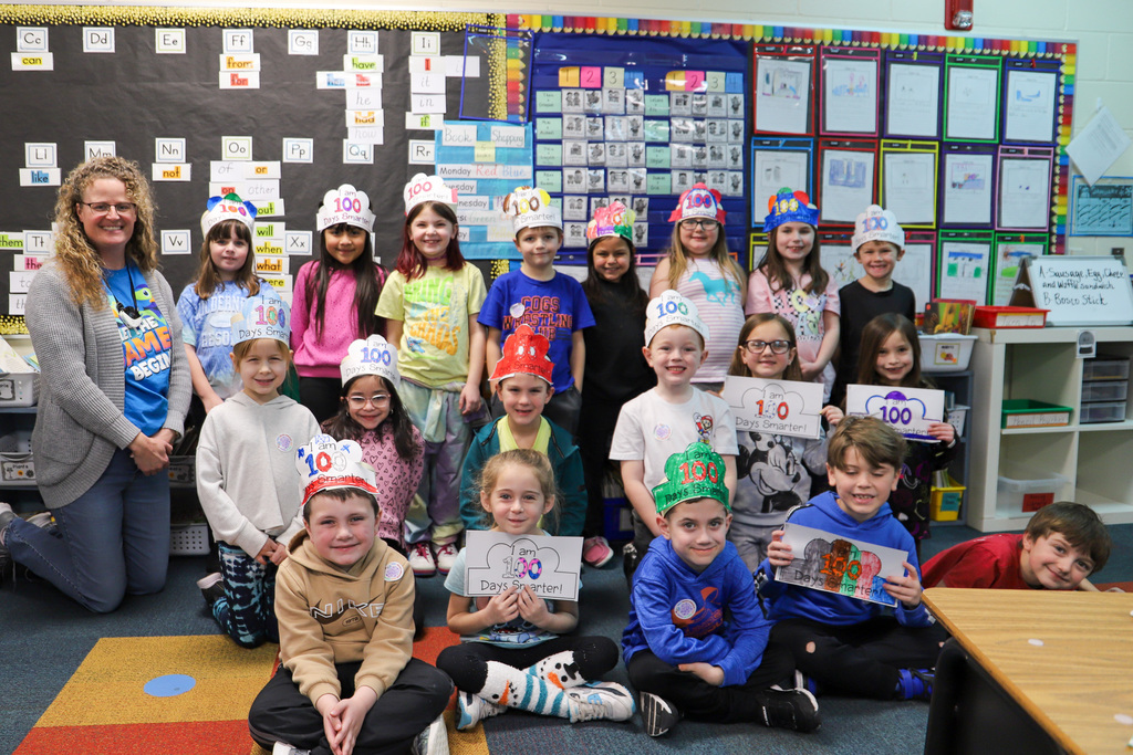 students smiling at camera wearing 100 days hats