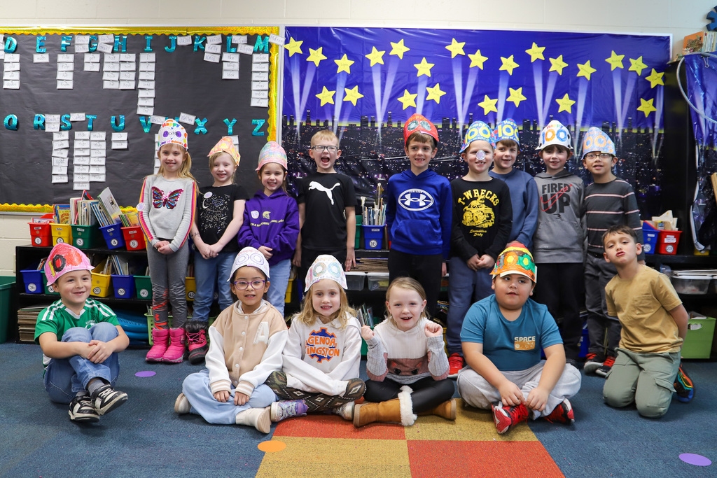 students smiling at camera wearing 100 days hats