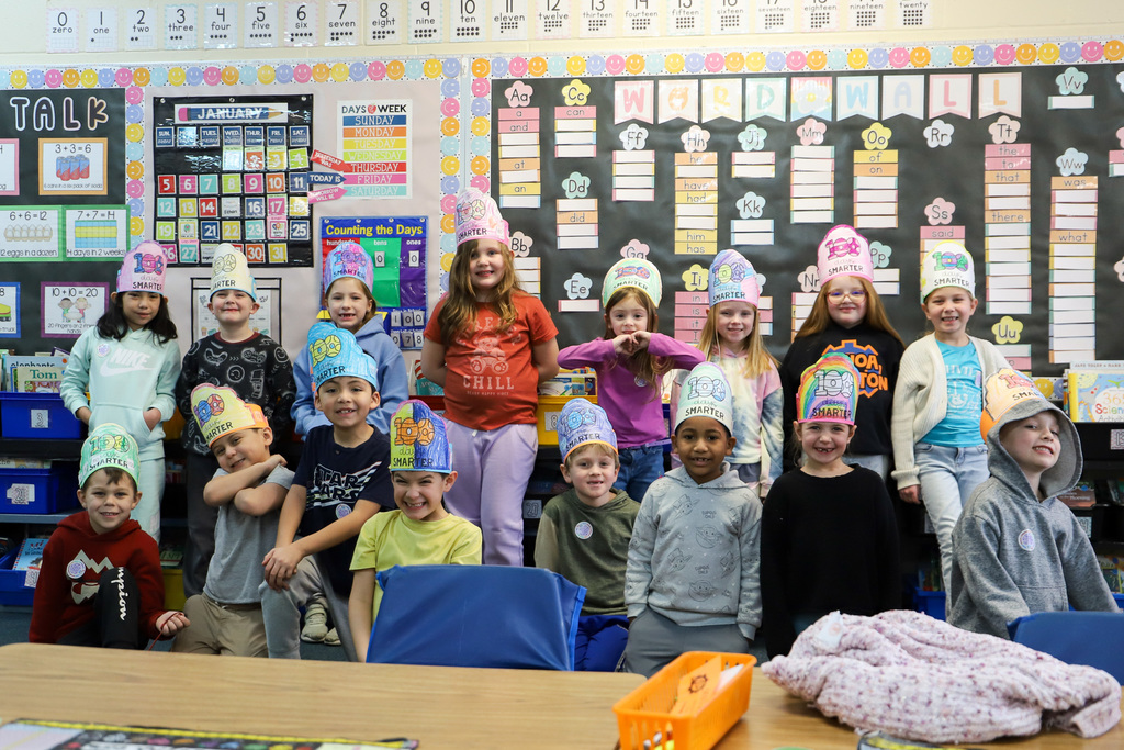 students smiling at camera wearing 100 days hats