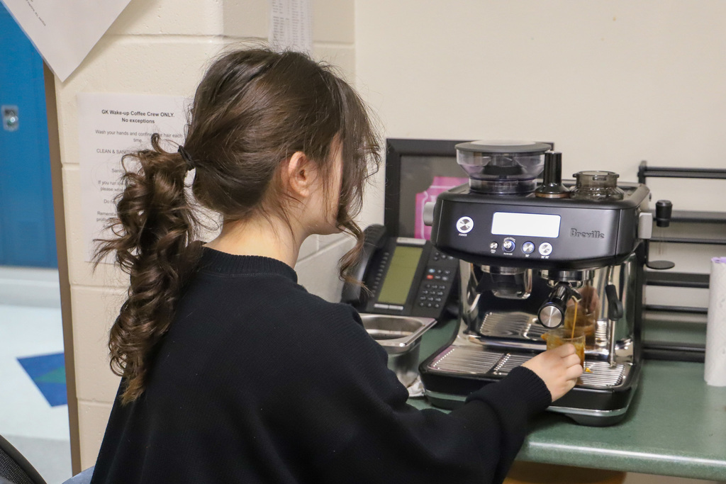 student making coffee