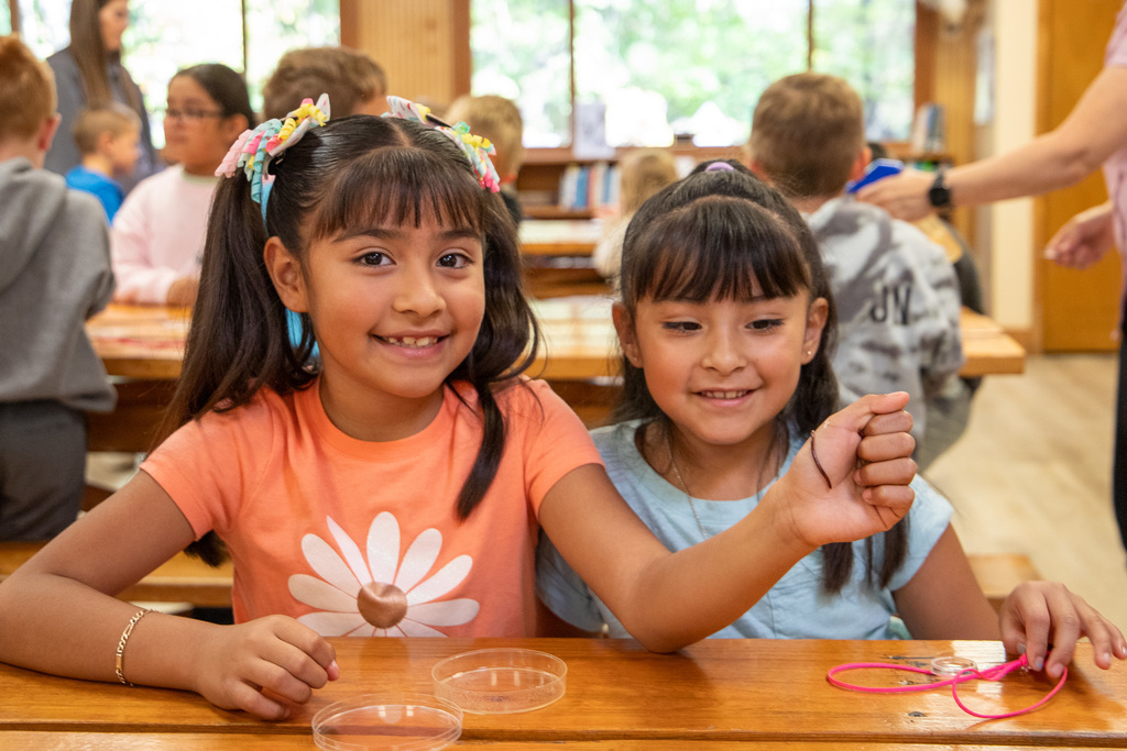 students holding worms