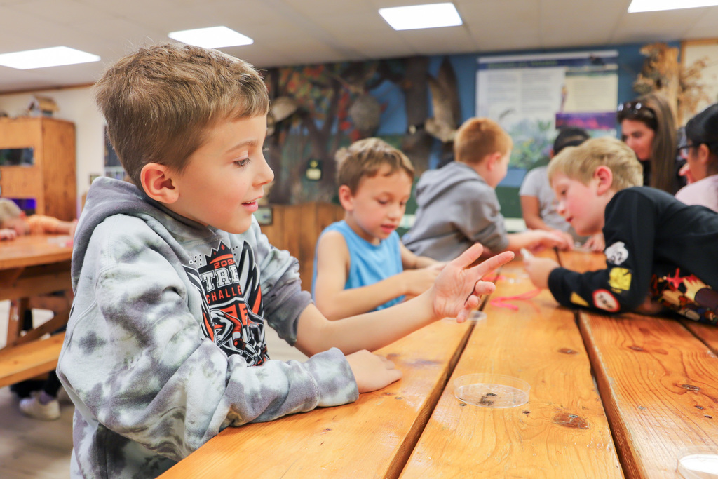students holding worms