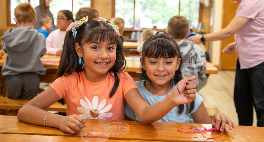 students holding worms