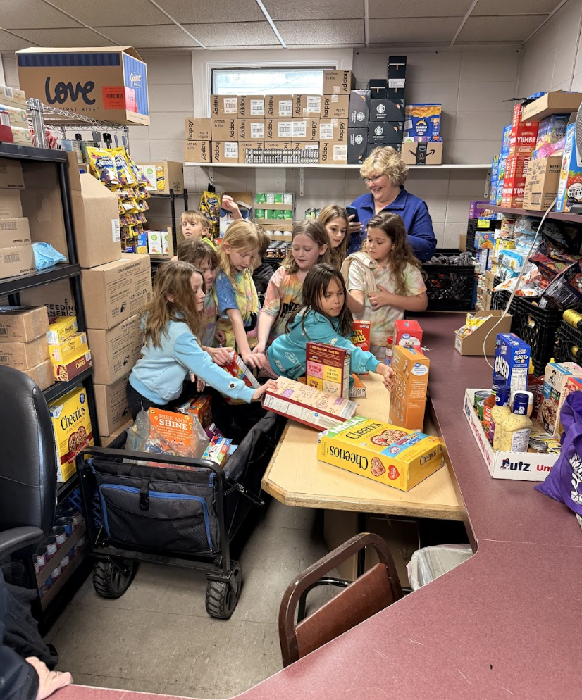 students organizing food at food pantry