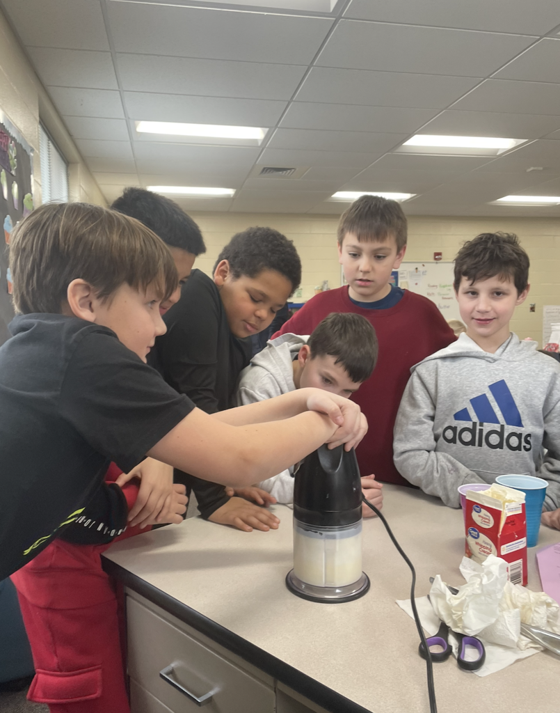 Students using mixer to mix butter