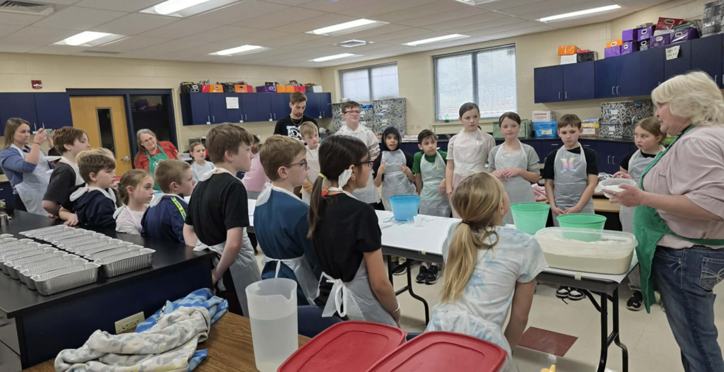 Students with 4H leader listening to directions