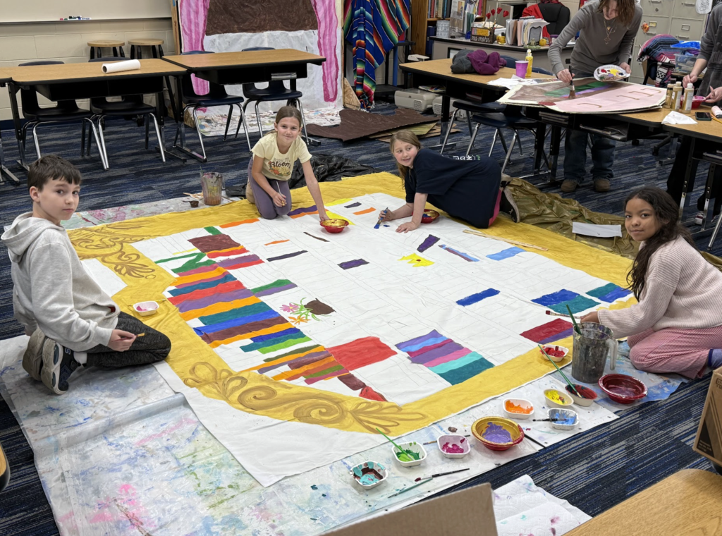 Students painting a set design for Beauty and the Beast show 1