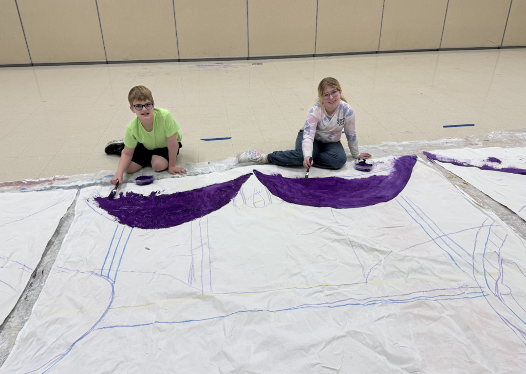 Students painting a set design for Beauty and the Beast show 3