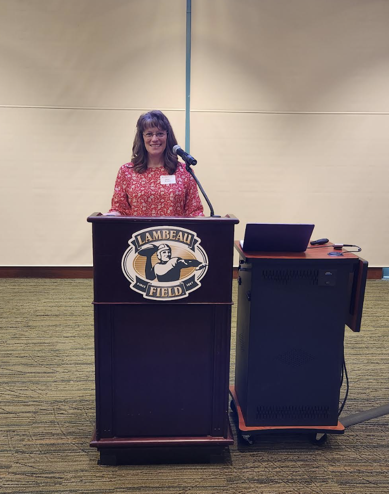 Ms. Bullock at podium presenting