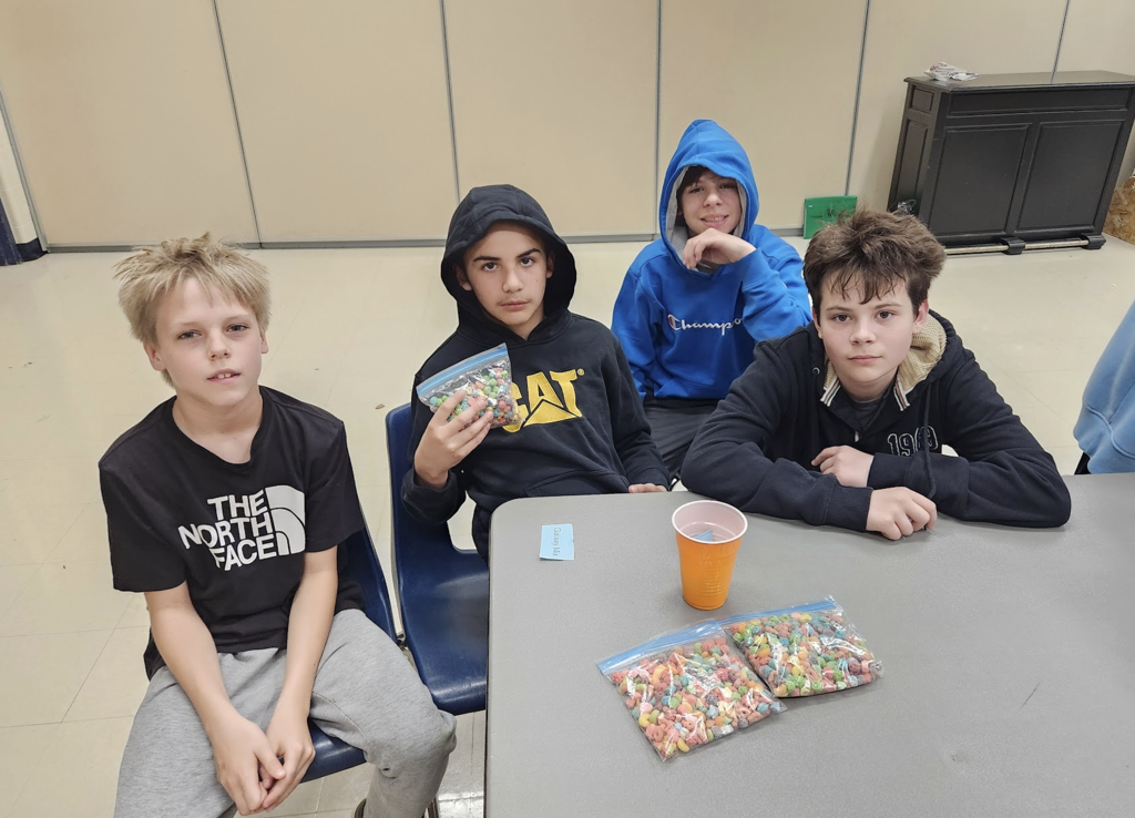 Group of students during entrepreneurship sale selling candy