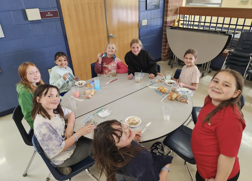 Students enjoying their purchases from the entrepreneurship sale together