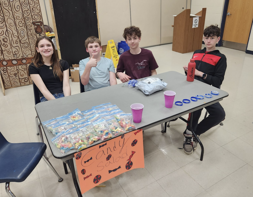 Entrepreneurs selling candy and bracelets during their sale