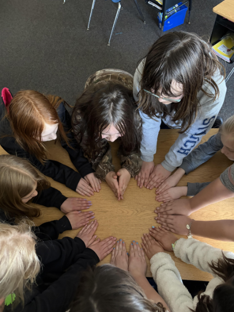 Students working together during Arbor Day in a collaborative group with one another