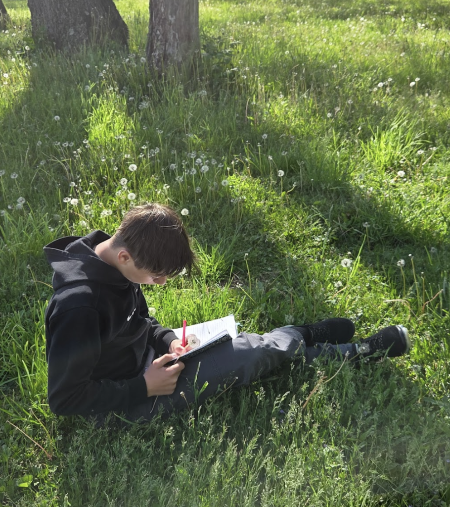 7th grade ELA students took advantage of the beautiful weather today by bringing their creative writing outdoors. As part of their current creative writing unit, students focused on developing strong setting and imagery by paying close attention to the world around them, what they could see, hear, smell, and feel in nature. Using the outdoors as inspiration, students worked to create vivid descriptions that help bring their writing to life. 3