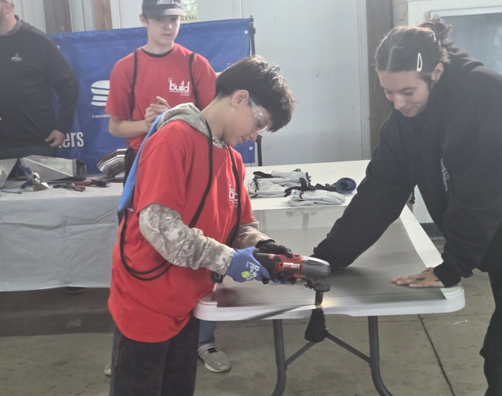 students cutting sheet metal