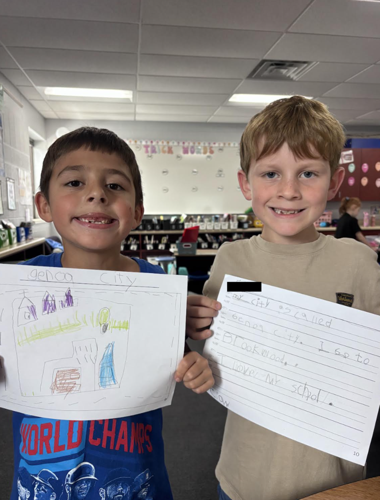 First Graders Showing Their Writing Pieces